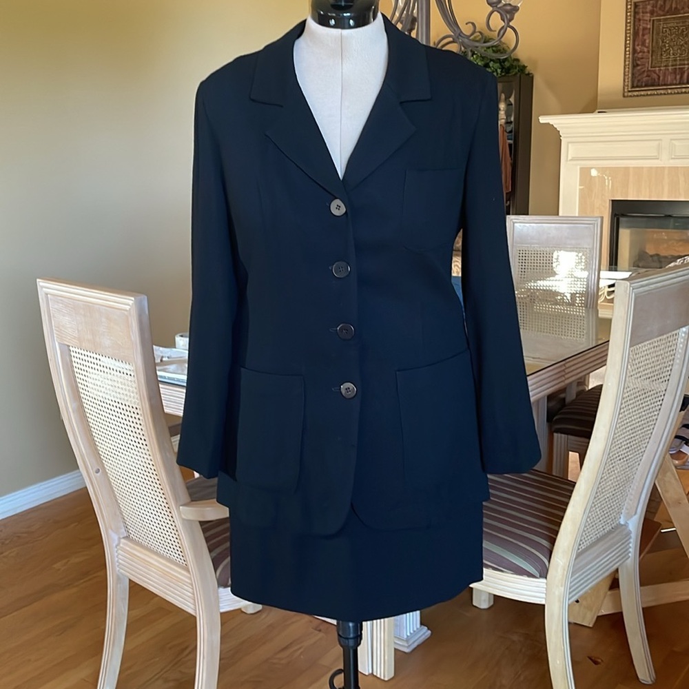 Two piece wool suit with mini skirt and longer jacket.  Four front buttons.